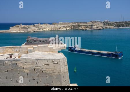 1979 passiert Bagger Saulus das Sleeping Soldier World war II Memorial. Denkmal für die 7.000 Toten während des Zweiten Weltkriegs. Grand Harbour, Valletta, Malta. Stockfoto