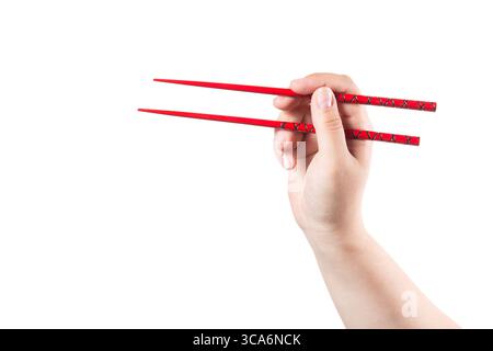 Hand mit roten Stäbchen isoliert auf weißem Hintergrund. Stockfoto