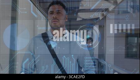 Büromitarbeiter, die unter Metallbalken entlang einer Glasbrücke laufen, mit digitalen HUD-Grafiken Stockfoto
