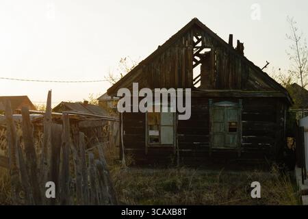 Ein altes hölzernes, verlassenes und zerstörtes Dorfhaus Stockfoto