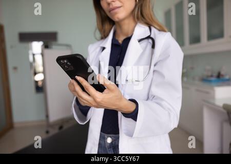 Zugeschnittener unerkennbarer Schuss einer Ärztin mit medizinischem Webservice Stockfoto