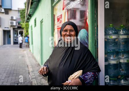 4. Dezember 2023, Bangkok, MalÃ, Malediven: Eine Frau mit Hijab-Lächeln auf der Straße in MalÃ. Das tägliche Leben in MalÃ, Malediven, der Hauptstadt des Inselstaates im Indischen Ozean, deren Wirtschaft stark vom Tourismus abhängt. Die Bevölkerung des Landes umfasst viele ausländische Staatsangehörige, die aus Nationen weltweit arbeiten, darunter die Philippinen, Myanmar, Sri Lanka und Indien. die Bevölkerung ist überwiegend muslimisch. (Kreditbild: © Matt Hunt/ZUMA Press Wire) Stockfoto