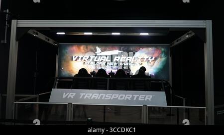 Besucher saßen in einem Virtual Reality VR Transporter Ride Experience in einer Attraktion des Unterhaltungs- und Wissenschaftszentrums. Stockfoto