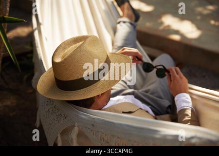 Mann in einer Hängematte mit Hut Stockfoto