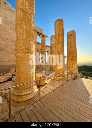 Goldene Stunde Sonnenuntergang am Eingang des Akropolis-Komplexes (Acrópole Propileia) in Athen, Griechenland, mit Touristen, die die Treppe hinunter laufen. Stockfoto
