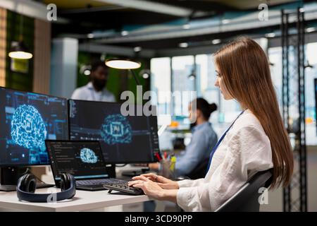 Weibliche Administratorin mit mehreren Geräten Beratung zu AI LLM Chatbot, um Tipps zur Verbesserung der Systemleistung zu erhalten. Junger Mitarbeiter eines Technikunternehmens, der ein Praktikum absolviert und sich bei der Automatisierung manueller Aufgaben auf KI-Assistenten verlässt Stockfoto