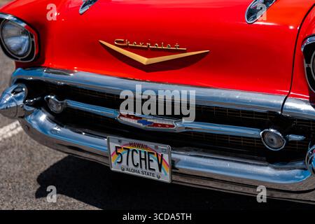 Kräftig rot 1957 Chevy Bel Air parkte im Sonnenlicht und präsentierte sein Chrom und seine Kurven. Eine zeitlose amerikanische Autokultur mit Nostalgie und Vintage Stockfoto