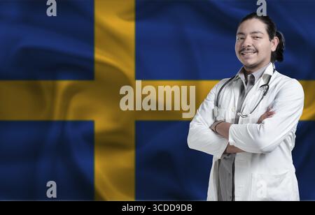Schwedisches Gesundheits- und Pflegekonzept. Männlicher Arzt auf schwedischer Flagge. Doktor mit gekreuzten Armen auf Schwedenflagge Stockfoto