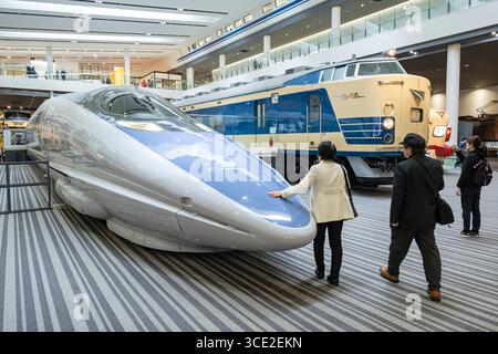 Frau, die die Nase eines 500-521-1 Shinkansen streichelt, der eine Betriebsgeschwindigkeit von 186 km/h erreichte, Kyoto Railway Museum, Kankijicho, Shimogyō-ku, Kyoto, Stockfoto