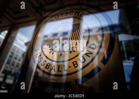 Berlin, Deutschland. August 2025. Das Logo des DFB (Deutscher Fußballverband) spiegelt sich in einem Fenster wieder. Berlin, 15. August 2025. Quelle: dpa/Alamy Live News Stockfoto