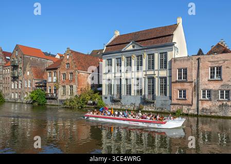 Bootstour mit Touristen auf dem Fluss Leie/Lys entlang mittelalterlicher Häuser im historischen Stadtzentrum von Gent im Sommer, Ostflandern, Belgien Stockfoto