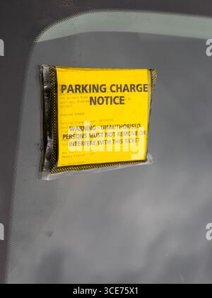 Gelber Hinweis auf Parkgebühren auf der Windschutzscheibe des Autos, Bahnhof Pewsey, Wiltshire, England, Großbritannien Stockfoto