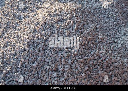 Detaillierte Ansicht des Hintergrunds aus zerquetschtem Stein. Konzept der Konstruktion, des Baumaterials, der Straßenbauarbeiten und der industriellen Textur. Stockfoto
