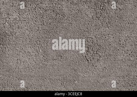 Dunkelgraue Pourus-Wandstruktur Mit Robuster Oberfläche. Raue Lackierte Strukturierte Oberfläche. Dunkelgrauer Betonhintergrund. Nahaufnahme.Pourus Wandfläche. Stockfoto