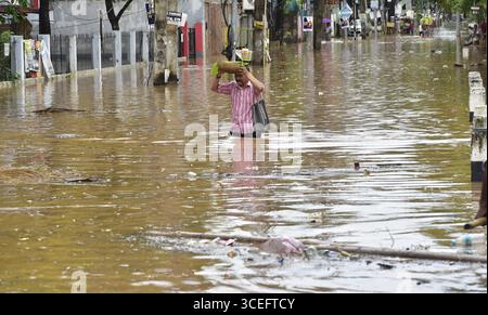 Guwahati, Guwahati, Indien. August 2025. Ein Mann wate durch die überflutete Straße nach Regen in Guwahati Indien am Sonntag, den 17. August 2025 (Foto: © Dasarath Deka/ZUMA Press Wire) NUR REDAKTIONELLE VERWENDUNG! Nicht für kommerzielle ZWECKE! Quelle: ZUMA Press, Inc./Alamy Live News Stockfoto