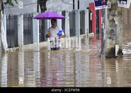 Guwahati, Guwahati, Indien. August 2025. Ein Mann wate durch die überflutete Straße nach Regen in Guwahati Indien am Sonntag, den 17. August 2025. (Kreditbild: © Dasarath Deka/ZUMA Press Wire) NUR REDAKTIONELLE VERWENDUNG! Nicht für kommerzielle ZWECKE! Quelle: ZUMA Press, Inc./Alamy Live News Stockfoto
