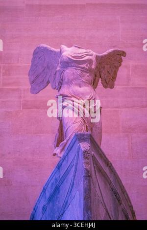 Paris: Louvre Museum, rosafarbenes Licht auf dem geflügelten Sieg von Samothrake oder Nike von Samothrake, Meisterwerk der griechischen Skulptur aus der hellenistischen Zeit Stockfoto