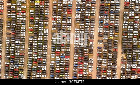 Luftaufnahme eines großen PKW-Parkplatzes mit Hunderten von Fahrzeugen – Konzept der Automobilindustrie und Lagerung Stockfoto
