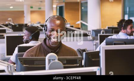 Reifer Geschäftsmann, Der Ein Telefon-Headset Trägt, Arbeitet In Der Kundendienstabteilung Stockfoto