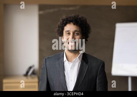 Fröhlich lächelnder tausendjähriger Mann im formellen Anzug, der in die Kamera schaut Stockfoto