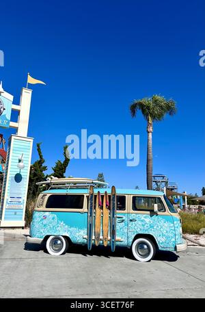 Ein Retro-Wohnmobil von Volkswagen mit Surf-inspiriertem Design, parkt mit Surfbrettern, die an der Seite an einer Strandattraktion in Kalifornien angebracht sind Stockfoto
