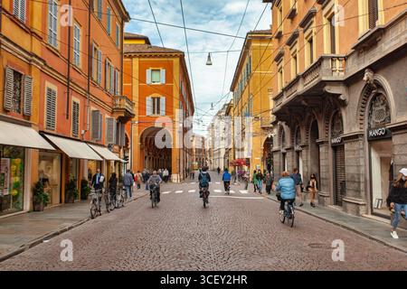 Modena, italien 20. august 2025: Touristen und Bürger wandern und radeln im historischen Zentrum von modena, italien Stockfoto