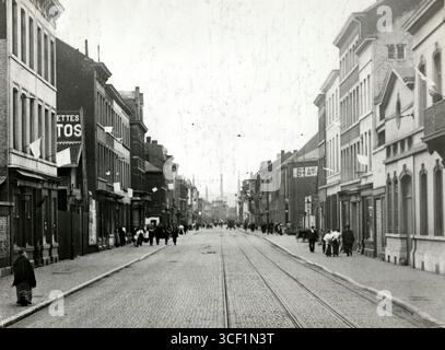 In einer von den Deutschen besetzten Stadt hängen kleine weiße Fahnen an Häusern in der Rue Guetry, Lüttich, Belgien, die auf die friedlichen Absichten der Bewohner während des Ersten Weltkriegs 1914 hinweisen. Stockfoto