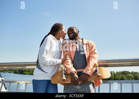 Das liebende Paar genießt einen wunderbaren Spaziergang entlang des Ufers, lächelt und teilt intime Momente. Stockfoto