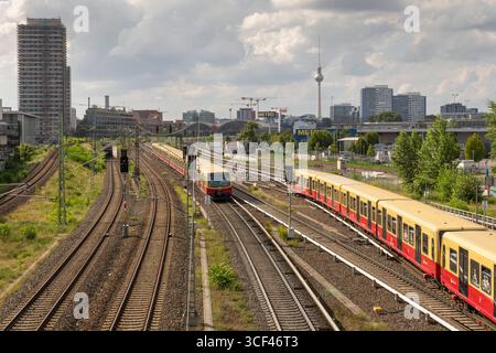Zwei S-Bahnen vor der Einfahrt in den S-Bahnhof Warschauer Straße in Berlin-Friedrichshain. In der Bildmitte im Hintergrund der Ostbahnhof und der Fernsehturm am Alexanderplatz. *** Zwei S-Bahn-Züge vor der Einfahrt in den S-Bahnhof Warschauer Straße in Berlin Friedrichshain in der Bildmitte im Hintergrund der Ostbahnhof und der Fernsehturm am Alexanderplatz Stockfoto