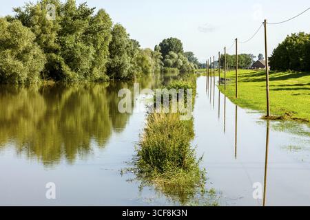 Überschwemmung nach Starkregen in Nordrhein-Westfalen, Naturschutzgebiet am Grietherort und Bienener Altrhein, Strassenüberflutung, Überschwemmung, Schwemmablagerungen Stockfoto