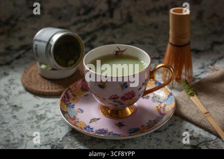 Matcha Latte in einer Teetasse mit Werkzeugen Stockfoto