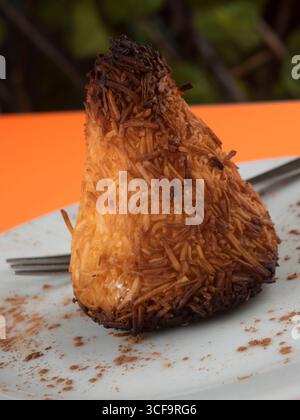 Golden Brown Coconut Macaroon auf weißer Platte Stockfoto