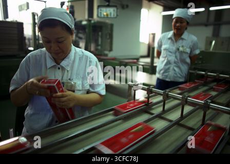 Frauen, die an einer Zigarettenproduktionslinie in Shanghai, China, arbeiten Stockfoto