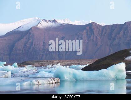 Gruppe von hellen blauen Eisbergen, die im Morgenlicht der Gletscherlagune von Jokulsarlon in Island schwimmen Stockfoto