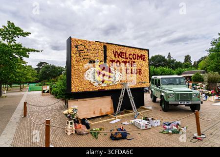 Eine große Plakatwand mit Blumendesign, die die neue Netflix-Serie The Thursday Murder Club im RHS Garden Wisley, Surrey, vorstellt Stockfoto