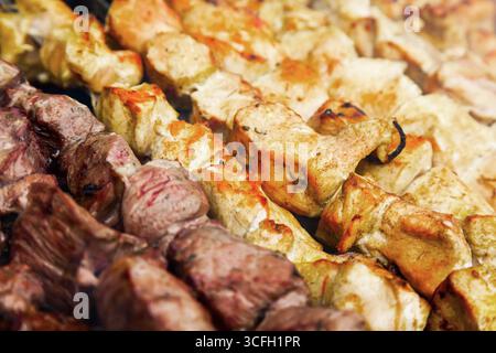 Hintergrund von Hühnchen und Lamm in Stücke geschnitten und auf dem Grill frittiert. Gebratener Kebab Hintergrund mit Huhn und Lamm. Stockfoto