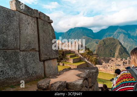 Inka-Steinterrassen und Ruinen in Machu Picchu mit den Anden und Wolken, die alte Architektur und das Kulturerbe Perus zeigen Stockfoto