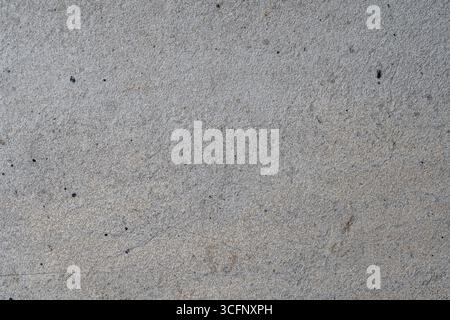 Grauer Betonmauerhintergrund oder Textur, Nahaufnahme Stockfoto