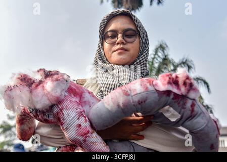 Bandung, Indonesien. August 2025. Ein Demonstrant repliziert blutbefleckte Wappen während einer Solidaritätsaktion für Palästina in Bandung, West-Java, Indonesien am 24. August 2025. In der Kundgebung forderten sie ein sofortiges Ende des Krieges und der Gewalt gegen Zivilisten in Palästina und forderten alle indonesischen Bürger auf, israelische Produkte zu boykottieren und die Gewalt gegen Journalisten im Gazastreifen zu beenden. (Foto: Dimas Rachmatsyah/SIPA USA) Credit: SIPA USA/Alamy Live News Stockfoto