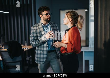 Kollegen diskutieren über die Arbeit in modernen Büroumgebungen Stockfoto