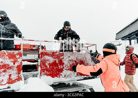 Sheregesh, Russland, 4. Januar 2021, Snowboarder, der im verschneiten Bergskigebiet aus der Schneekatze steigt Stockfoto
