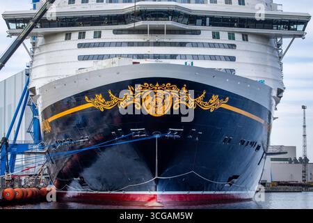 Wismar, Deutschland. August 2025. Das Kreuzfahrtschiff „Disney Adventure“ liegt am Ausbaukai der Werft Wismar. Nach rund sieben Jahren Bauzeit wird eines der größten Kreuzfahrtschiffe der Welt in den nächsten Tagen die Hansestadt verlassen. Die US-Reederei Disney Cruise Line übernahm das Schiff vom Insolvenzgut und lässt es von der Meyer Werft in Papenburg, Niedersachsen, bauen. Das Schiff wird ab Ende 2025 für die Disney Group in Südostasien im Einsatz sein. Quelle: Jens Büttner/dpa/Alamy Live News Stockfoto