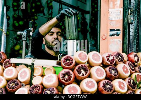Istanbul, Türkei, 9. Mai 2018, Mann Verkäufer, der frisch gepressten Zitrussaft in Street Food Stände herstellt Stockfoto