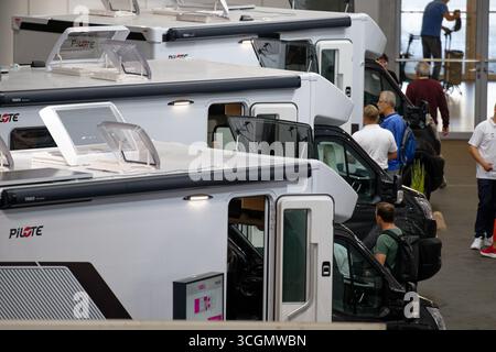 Düsseldorf, Deutschland. August 2025. Besucher gehen durch Hallen mit Mobilheimen auf der „Caravan Salon – Fachmesse für Caravaning, Camping und Outdoor-Tourismus“. Bis Zum 7 . Im September präsentieren mehr als 810 Aussteller in 15 Messehallen und auf dem Freigelände das Branchenangebot. Quelle: Henning Kaiser/dpa/Alamy Live News Stockfoto