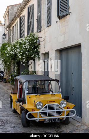 Mini Moke Car vor einem kleinen Haus in der ruhigen Stadt Saint Martin de Re, Frankreich. Stockfoto