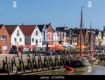 Husum, Deutschland - 30. Juni 2025: Blick auf das idyllische Stadtzentrum von Husum in Norddeutschland mit Booten, die bei Ebbe im Hafen liegen Stockfoto