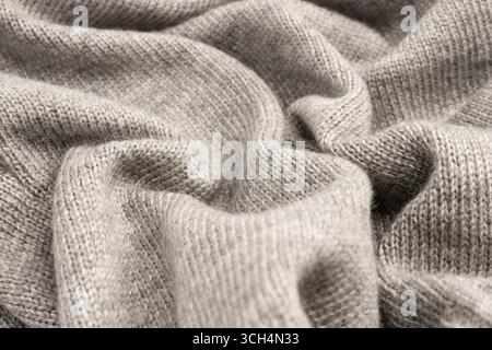 Graue Wollpullover-Textur als Hintergrund. Draufsicht. Stockfoto