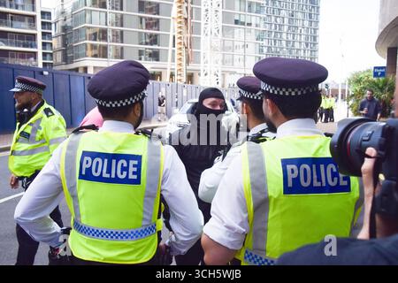 London, Großbritannien. 31. August 2025. Antimigrantische, maskierte Gegenprotestierende werden von Polizisten zurückgehalten, während sich Demonstranten vor dem Britannia International Hotel in Canary Wharf zur Unterstützung von Migranten versammeln, wo Asylsuchende untergebracht sind, Teil der laufenden Demonstrationen im Zusammenhang mit Migranten, die in ganz Großbritannien stattfinden. Quelle: Vuk Valcic/Alamy Live News Stockfoto