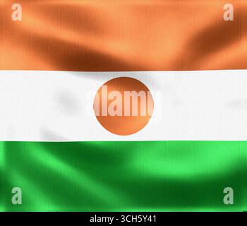 Die schwingende Flagge von Niger zeigt leuchtende Farben in Orange, weiß und Grün, mit einem orangefarbenen Kreis in der Mitte, der den Nationalstolz symbolisiert Stockfoto