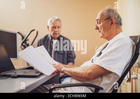 Kardiologische Beratung bei einem älteren männlichen Patienten bei einer detaillierten Herzuntersuchung in einer medizinischen Klinik. Stockfoto